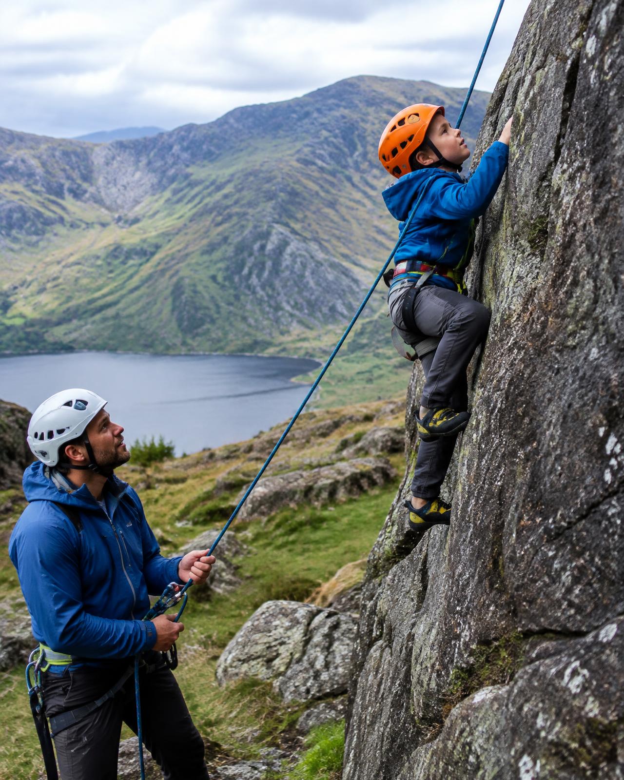 A child rock climbing with an instructor belaying (placeholder image)